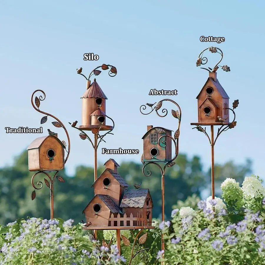 Decorative birdhouse stakes in garden